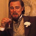 Leonardo DiCaprio as Calvin Candie holding a drink with a smug, skeptical expression.