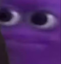 Purple face with wide, unblinking eyes staring directly forward with a deadpan expression.