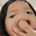 A person poking their nose with their finger in a close-up, distorted, and humorous perspective.