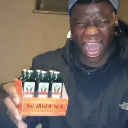 A man with an excited expression holding up a pack of Jägermeister shots.