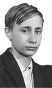 Young Vladimir Putin looking directly at the camera with a serious and stoic expression.