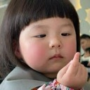 A young child with a bob haircut looking skeptical while holding her thumb and index finger together to show a tiny amount.
