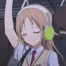 Anime girl with headphones on her head and eyes closed in a peaceful expression.