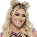 Alexa Bliss smiling with her hair styled in two buns.
