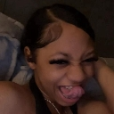 A person sticking their tongue out with a playful and mischievous expression.