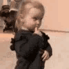 A toddler looking sideways with a suspicious and judgmental facial expression.