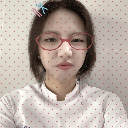 Person wearing red glasses looking at the camera with a skeptical and unimpressed expression.