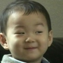 A young child with a smug, knowing smirk on their face.