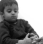 A young child looking down with a skeptical and unimpressed facial expression.