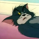 Tom Cat lying down with a tired and annoyed expression.