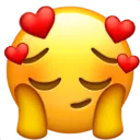 Yellow emoji face with closed eyes and hands on cheeks, surrounded by floating red hearts.