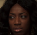 Woman looking to the side with a skeptical and judgmental facial expression.