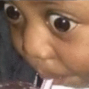 Child with extremely wide, bulging eyes staring directly forward in shock.