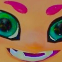 A character face with bright green eyes and a wide, sharp-toothed mischievous grin.