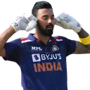 Cricket player wearing a blue jersey with fingers in his ears to block out sound.