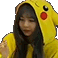 Girl wearing a yellow Pikachu hoodie with hands clasped together in a prayer gesture.