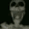Skeleton face with a wide, shocked expression and high-contrast dark aesthetic.