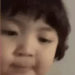 A young child looking at the camera with a skeptical and judging facial expression.