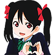 Nico Yazawa making a heart shape with her hands while smiling.