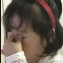 A person covering their eyes with their hand in a gesture of frustration.