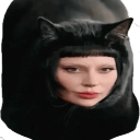Lady Gaga wearing a black cat-ear hood looking directly at the camera.
