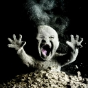 A dusty baby emerging from a pile of dirt with a wide-open screaming mouth and raised hands.