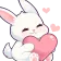 A white bunny with closed eyes holding a large pink heart.