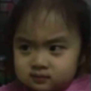 A young girl looking sideways with a skeptical, judgmental, and suspicious facial expression.