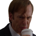 Jimmy McGill making a disgusted face while holding a white coffee cup.