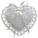Lace heart with a ribbon, featuring intricate white patterns.