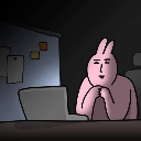 A pink rabbit-like character with a neutral expression sitting at a desk in the dark, staring at a glowing laptop screen.