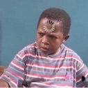 Osita Iheme looking confused with a digital loading icon superimposed on his forehead.