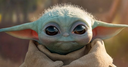 Grogu looking forward with large, curious dark eyes and a soft, neutral expression.