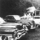 Vintage cars parked in a row captured in a black and white photograph.