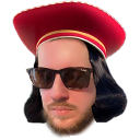 Man wearing a red Lord Farquaad hat and sunglasses looking smugly at the camera.