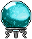Crystal ball glowing with turquoise light sitting on a silver stand.