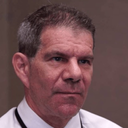 Dave Meltzer looking into the camera with a serious and skeptical expression.
