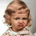 Young girl making a skeptical, disgusted face with her lips pursed.