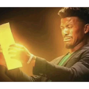 Jimmy Butler stares at a glowing paper with a shocked and confused facial expression.