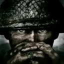 Soldier wearing a helmet with hands covering their face in a gesture of intense stress.