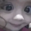 Baby face with wide, unblinking eyes staring directly forward.