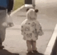 Toddler in a panda hoodie waddling away from the camera.