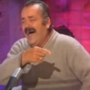 Juan Joya Borja laughing hysterically while pointing his finger.