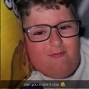 Person wearing glasses with a smirk and a suggestive expression.