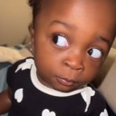 Toddler looking sideways with a skeptical and judgmental expression.