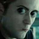 Edward Cullen looking at the camera with wide, shocked eyes and a tense mouth.