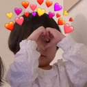 Toddler making a heart shape with their hands while wearing a digital crown of floating hearts.