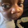 A baby looking sideways with a skeptical and judgmental expression.