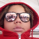 Person wearing a red hoodie and reflective sunglasses looking directly at the camera.