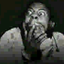 Person with wide eyes and hands covering their mouth in a look of pure terror.